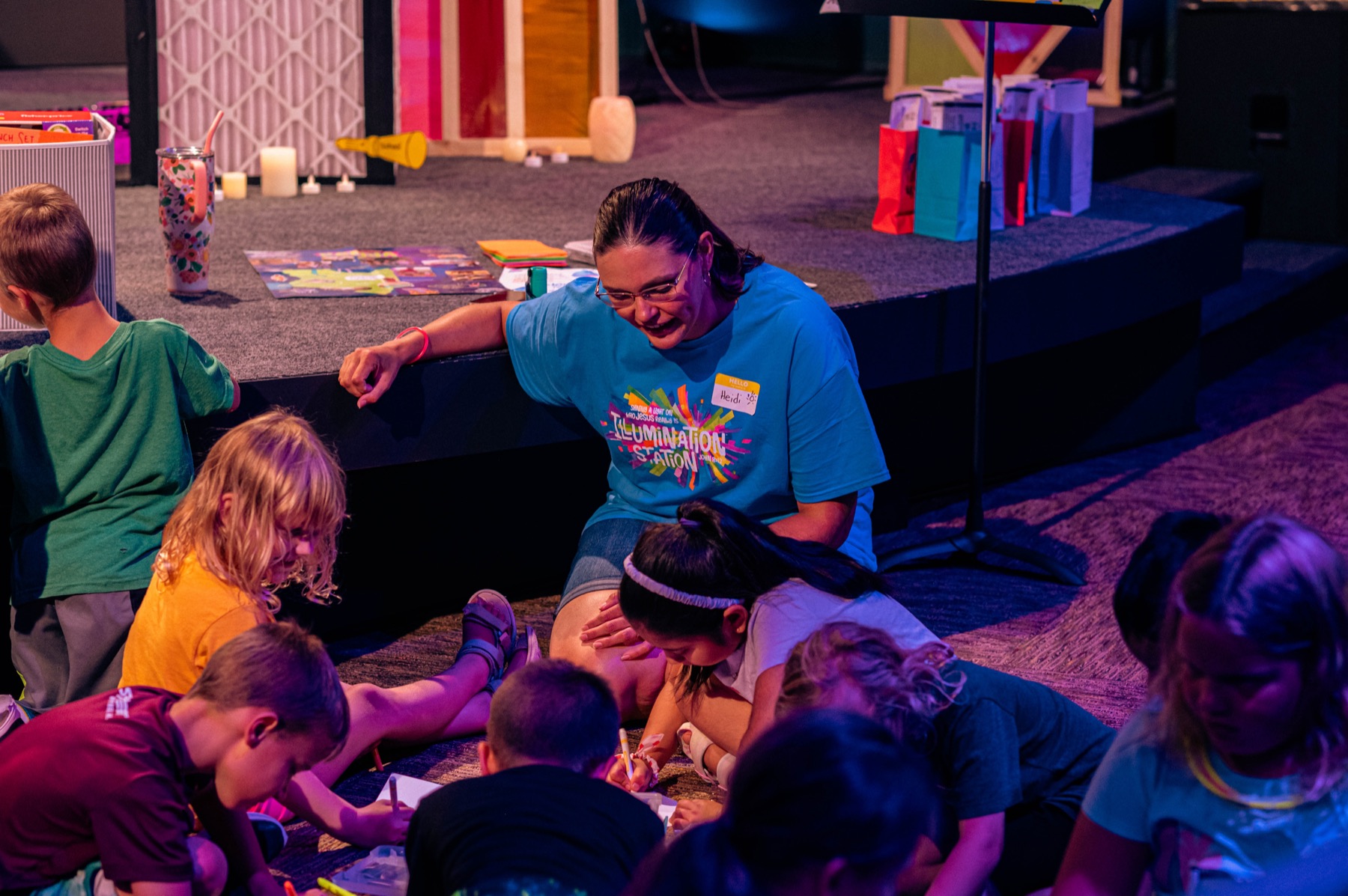 Kids coloring with a volunteer